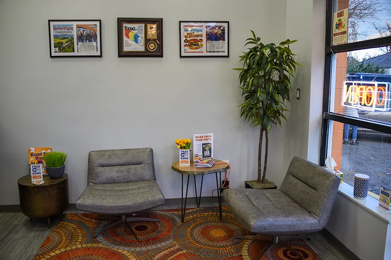 Cozy waiting area with chairs, table, and decorations.